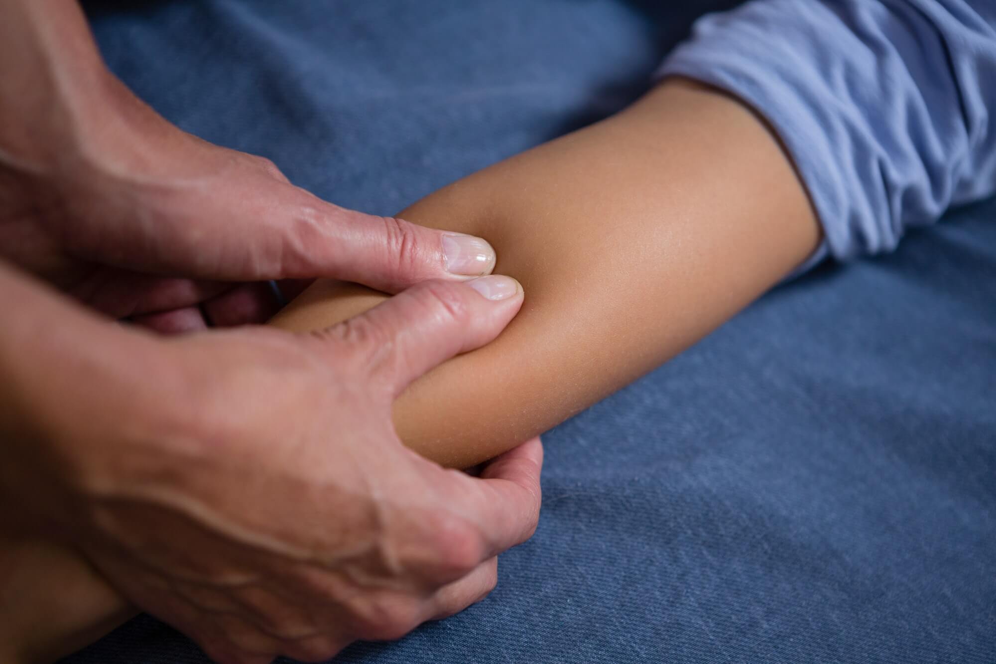 Physiotherapist giving hand massage to patient