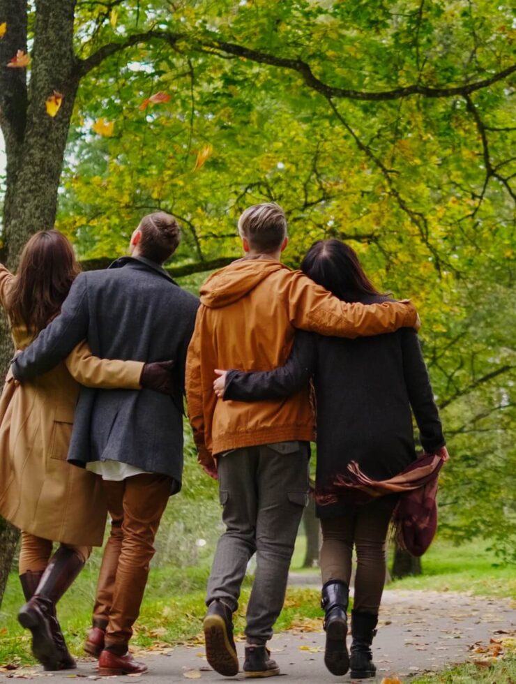 Friends walking in autumn park