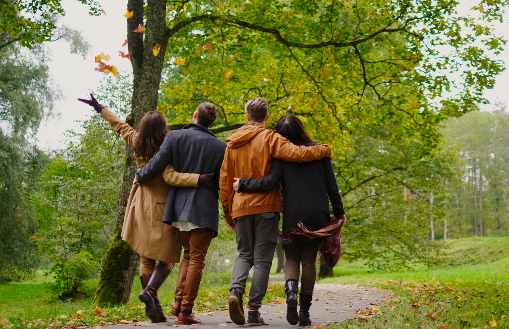 Friends walking in autumn park