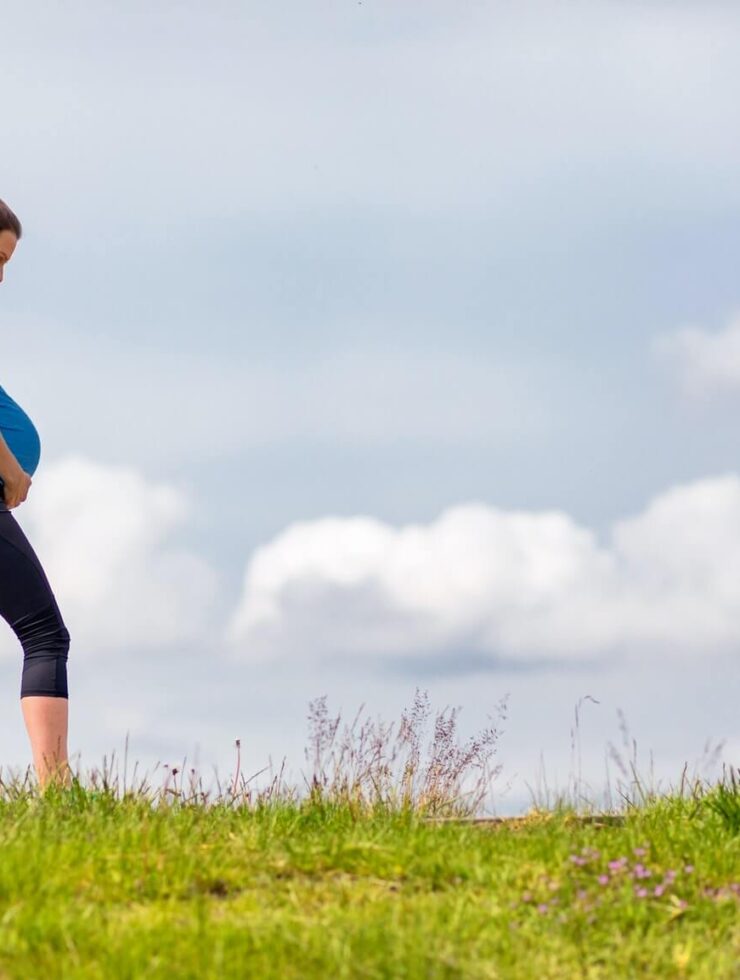 Pregnant woman walking in the park