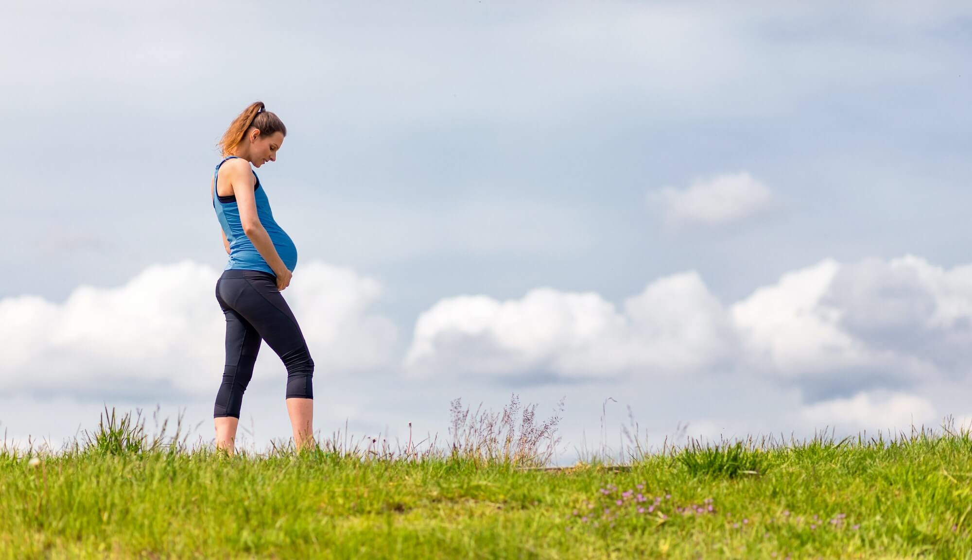 Pregnant woman walking in the park